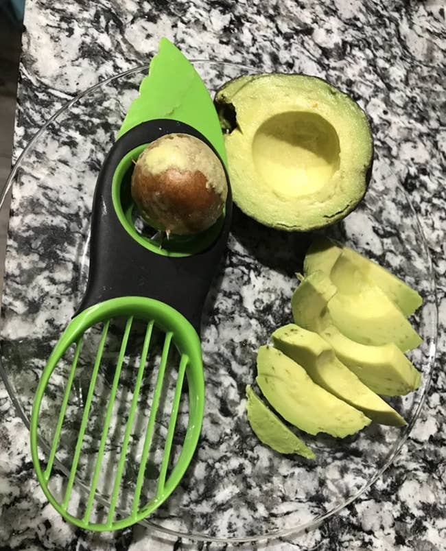 A customer review photo of their tool next to a sliced avocado