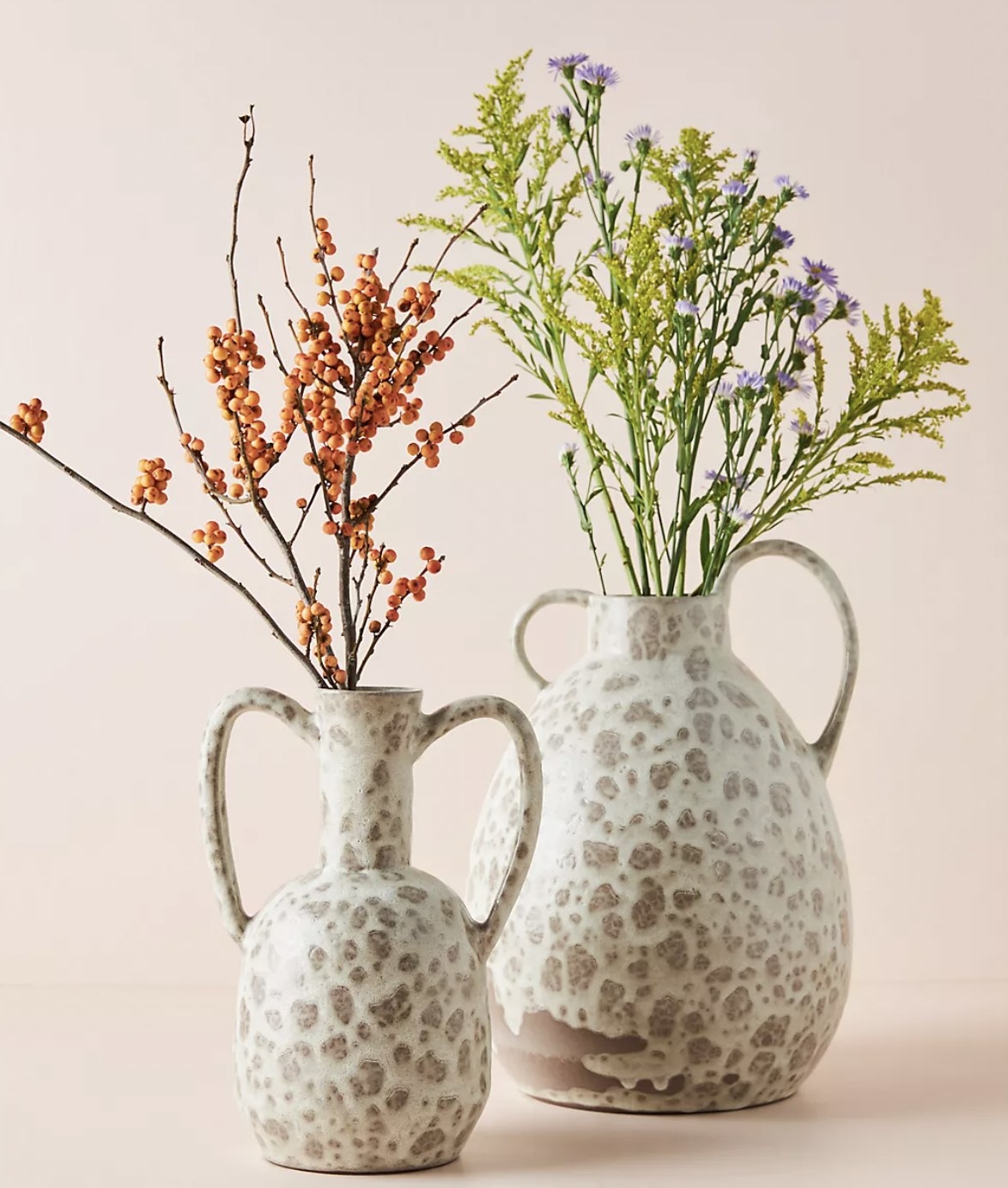 the vase in a white and beige design in both the small and large sizes