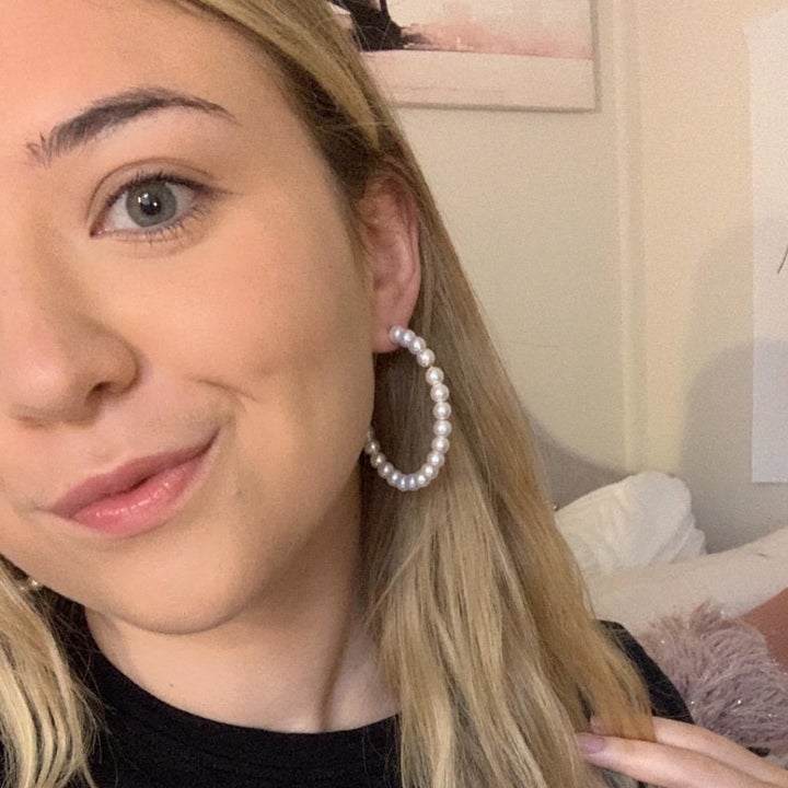 Reviewer wearing the pearl hoop earrings