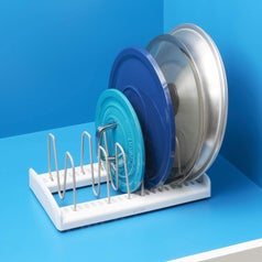 The lid organizer inside a kitchen cabinet