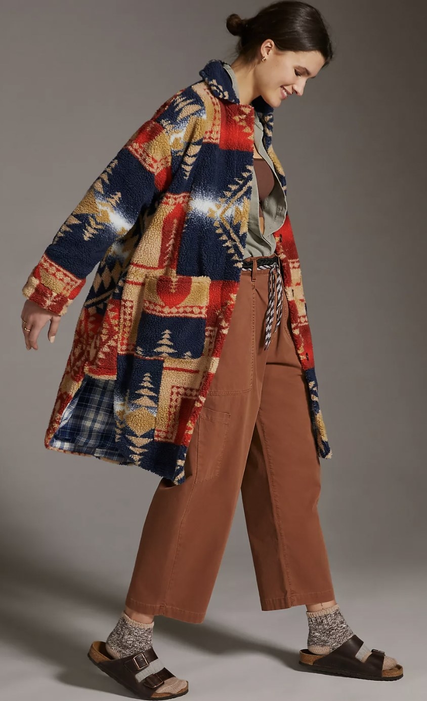 model wearing the duster in a navy, tan, and red design