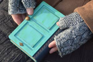 leather bound book that looks like teal door with 21 sign over the top