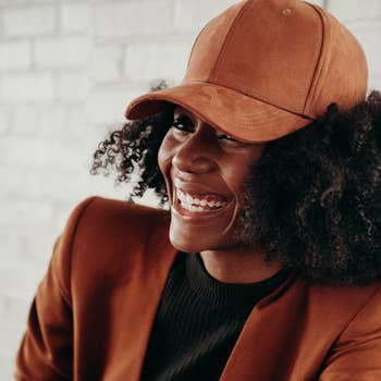 a model wearing the brown suede hat