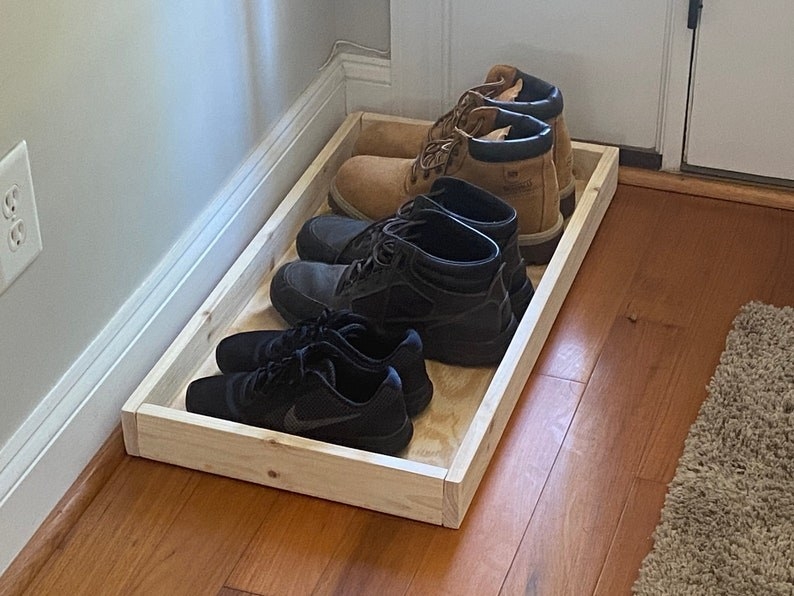 Set of three shoes placed in boot tray