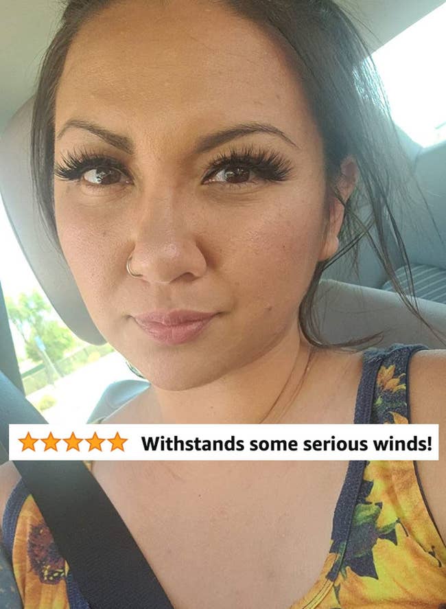 A reviewer wearing false eyelashes and review text 