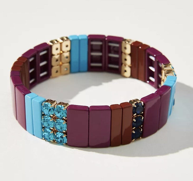 the bracelet with red, brown, blue and green pieces with black and blue rhinestones