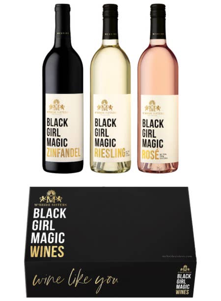 three wine bottles with a black gift box