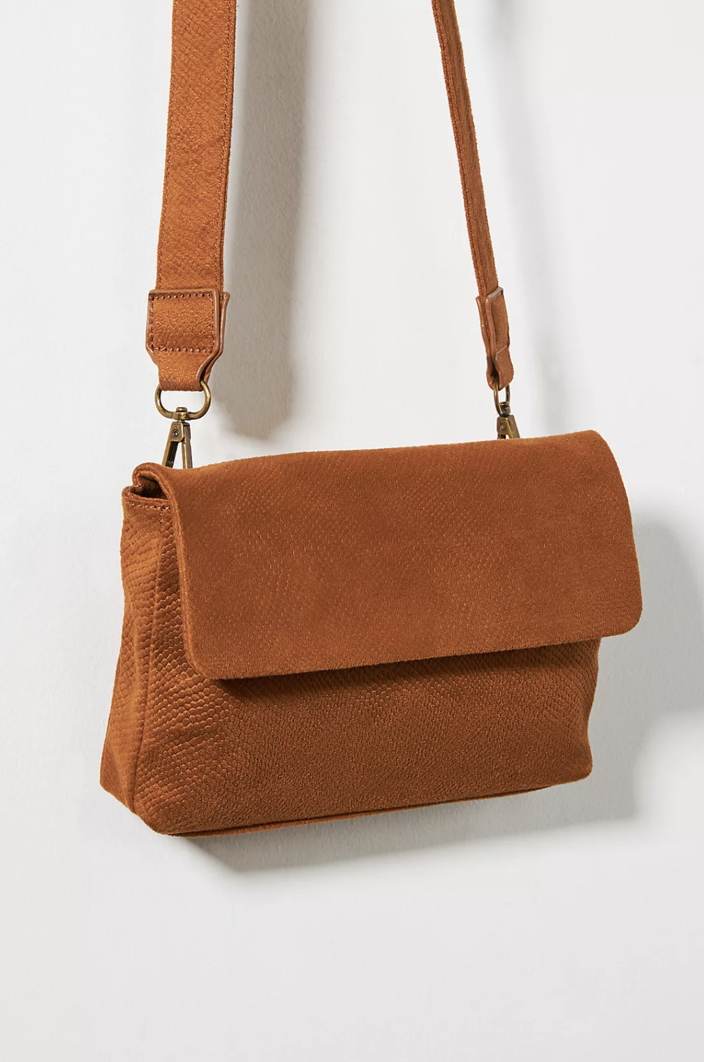 the crossbody bag in a semi-patent brown