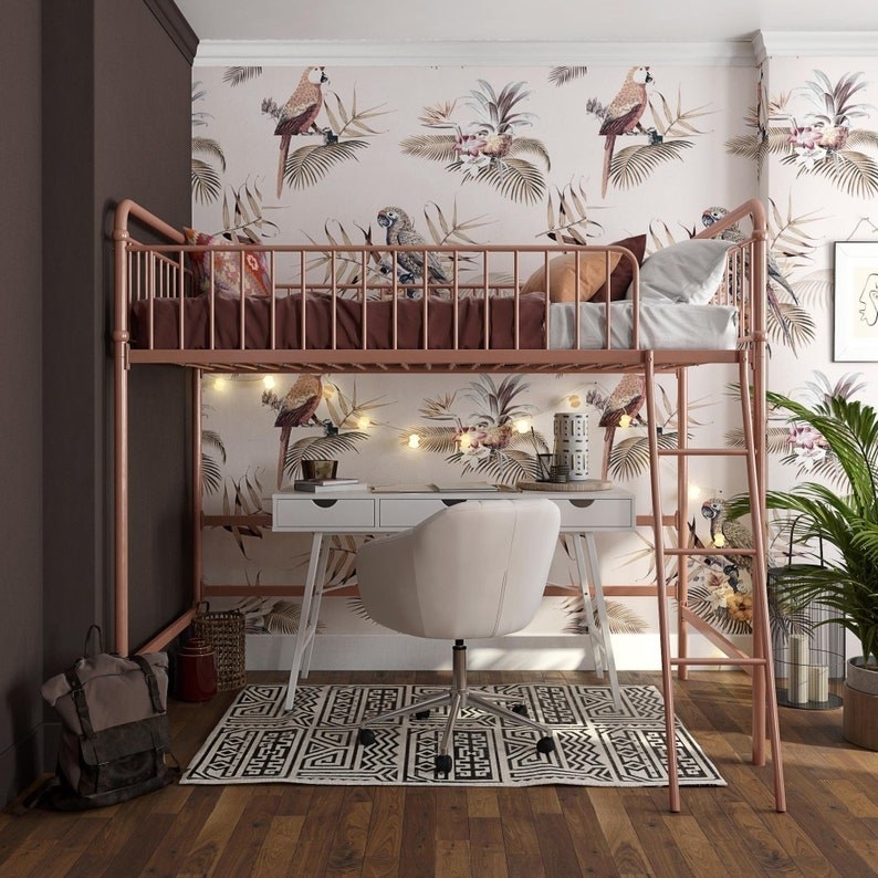 the rose gold loft frame with a twin bed on it and desk and chair underneath it