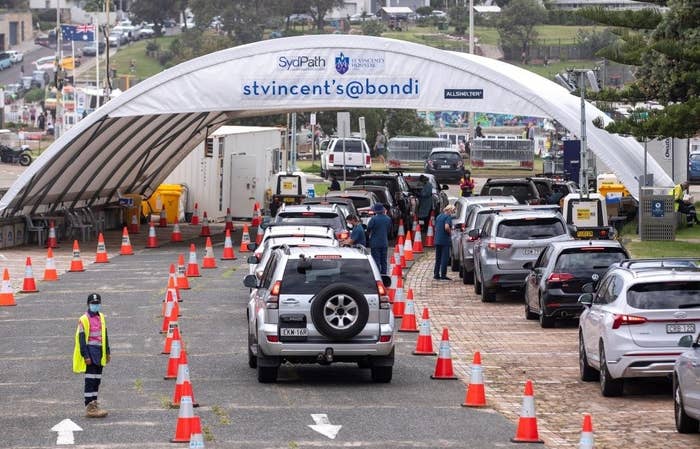 People wait for COVID-19 tests at a testing site in Sydney, Australia