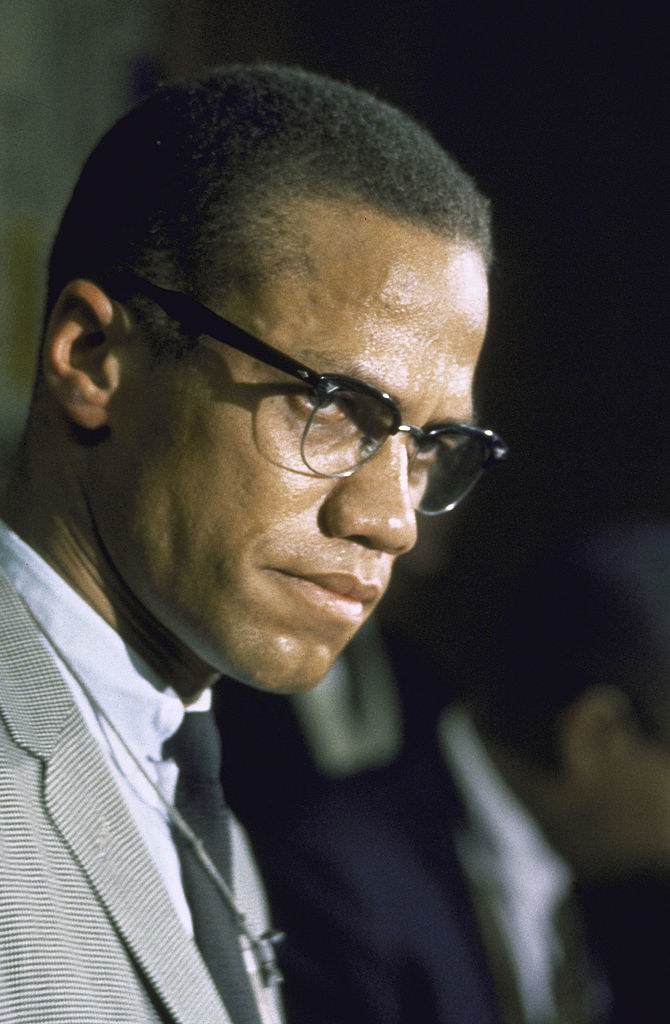 Malcolm X looks seriously at a crowd