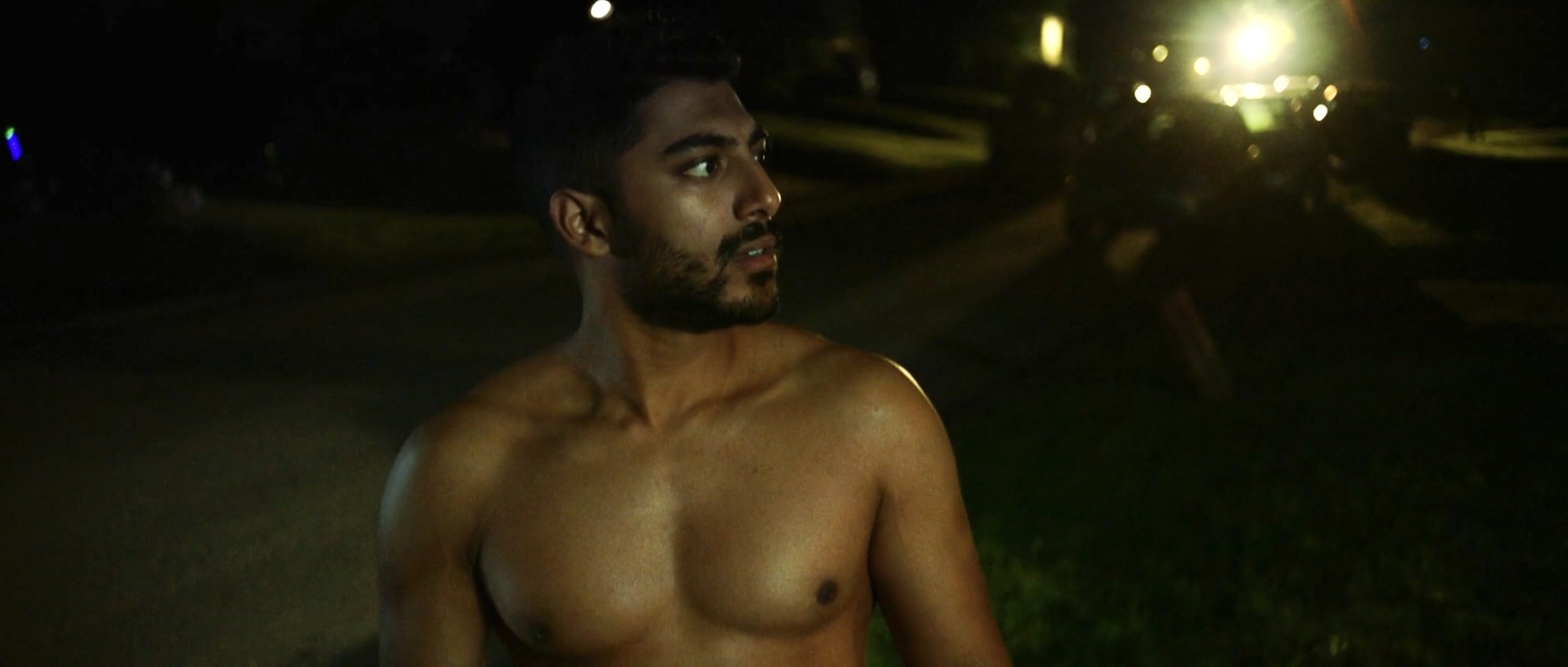 Sonny shirtless in the street
