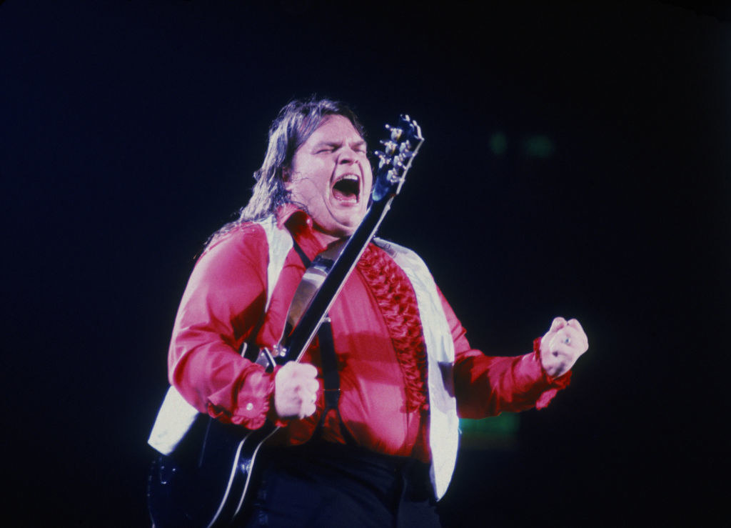 shot of Meat Loaf on stage, he&#x27;s holding a guitar