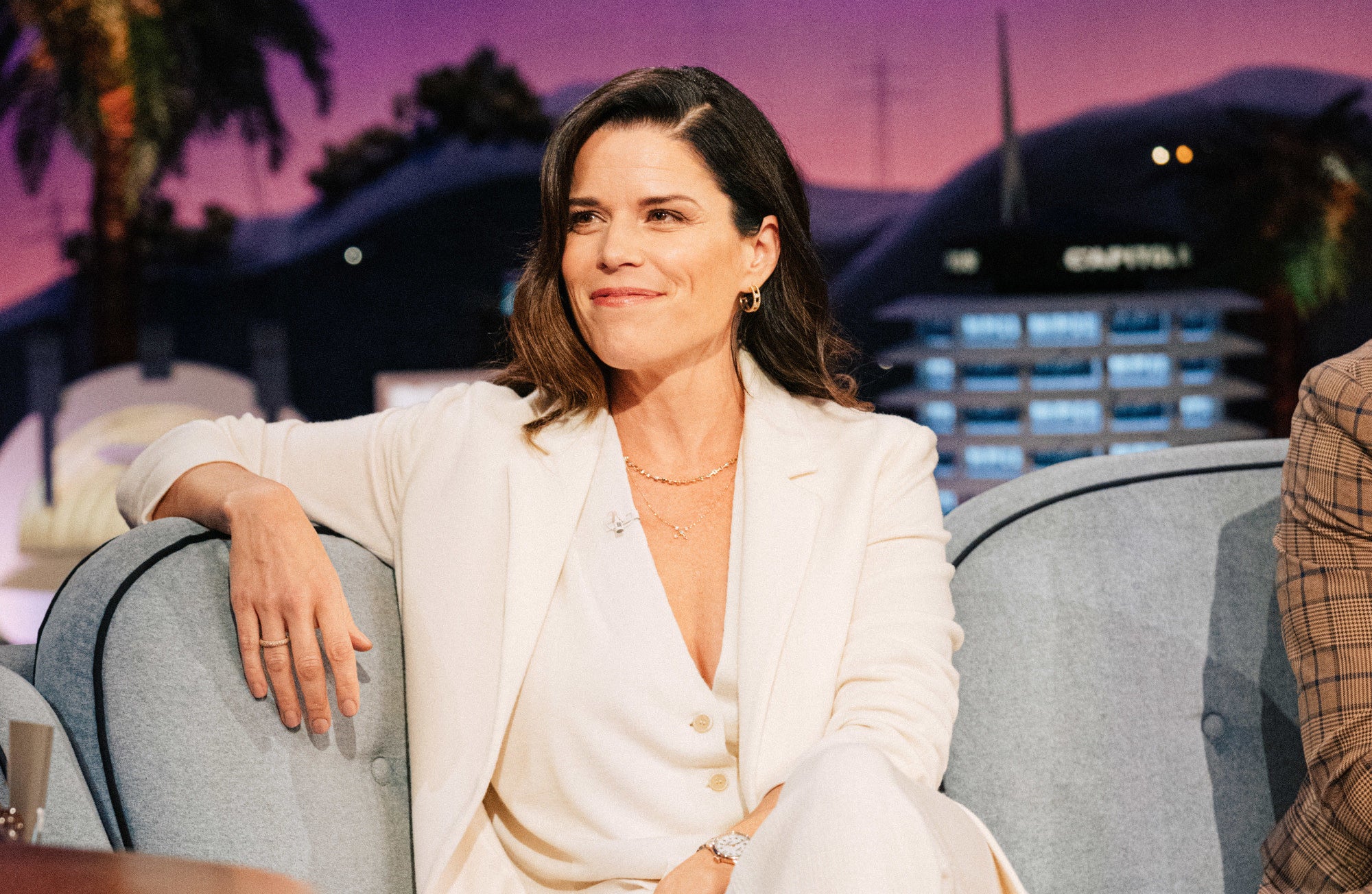 Neve Campbell in a white suit