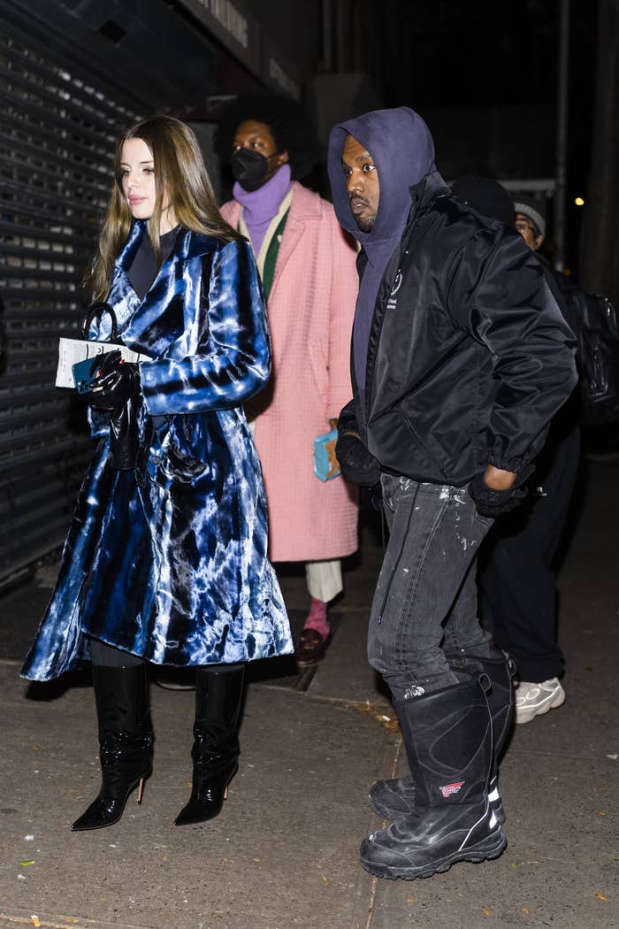 The couple walking outside at night