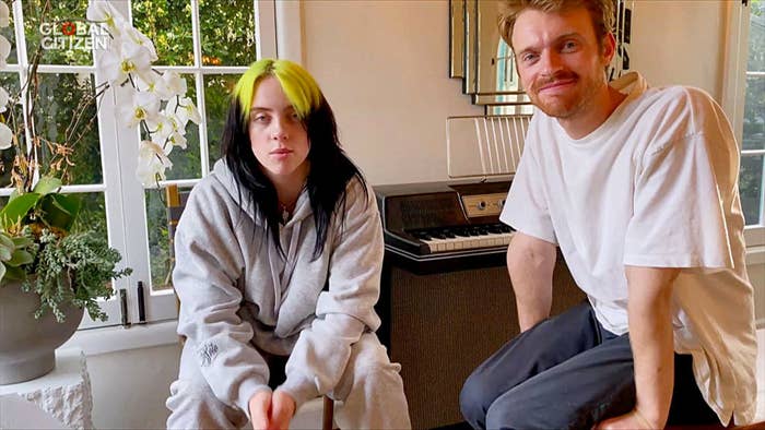 Billie and Finneas sitting by keyboards