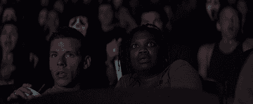 GIF of the audience being scared at Stab in Scream 2