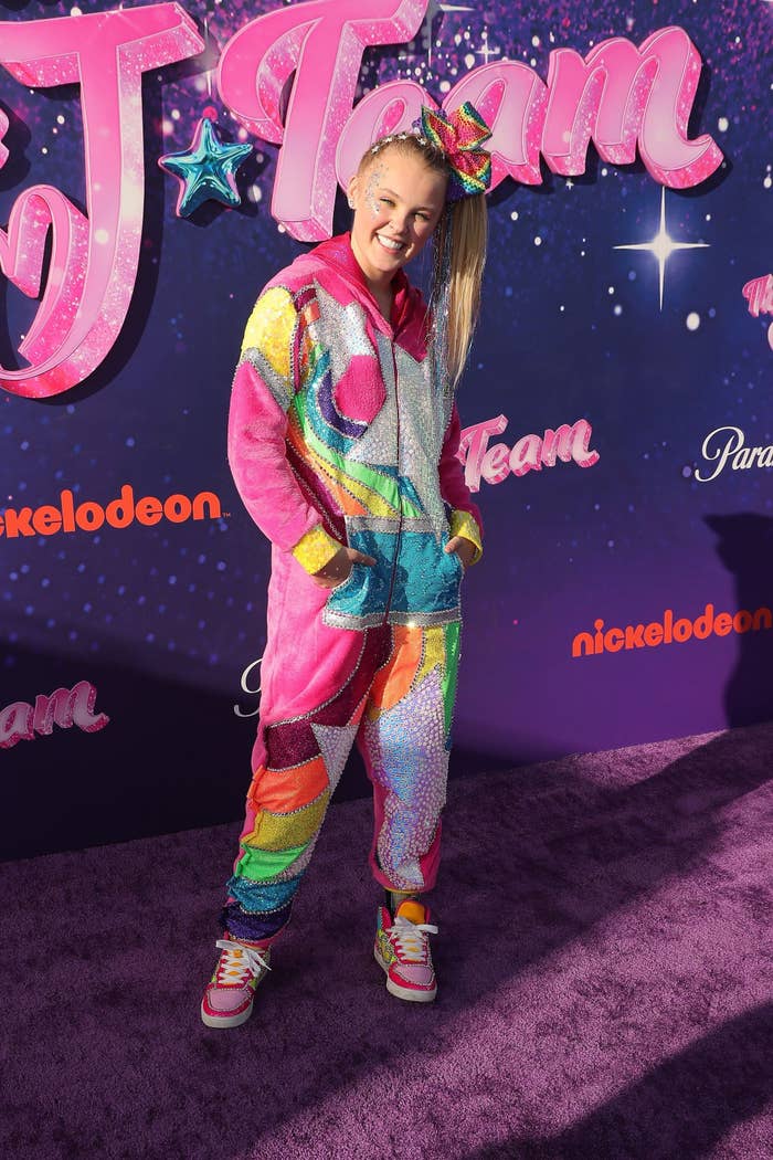 JoJo in a colorful outfit and sneakers