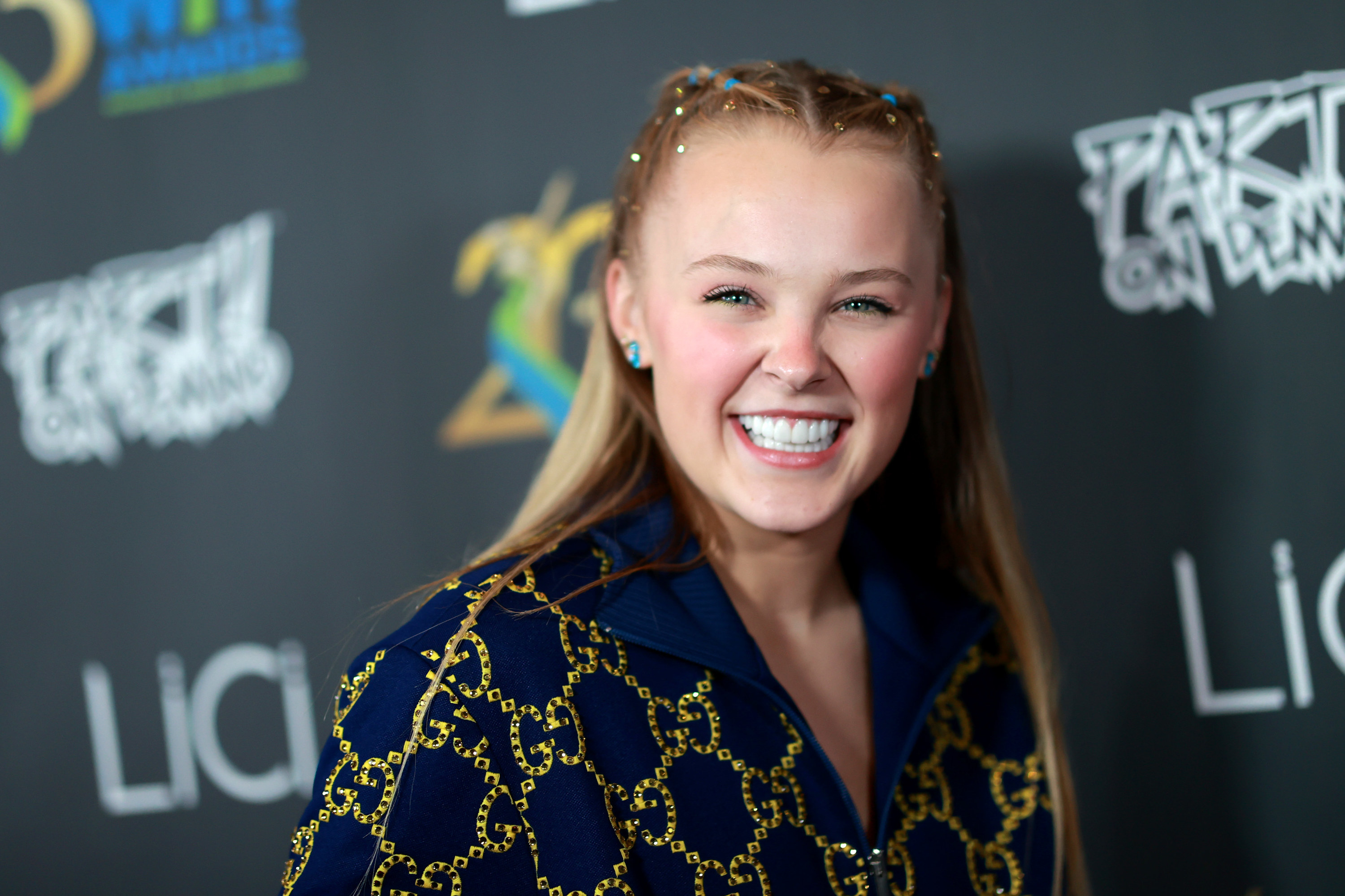 Headshot of JoJo smiling on the red carpet