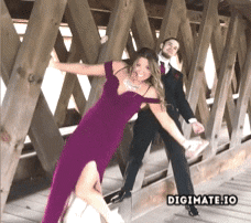 Bridesmaid falling over while trying to pose next to a groomsman in a photo