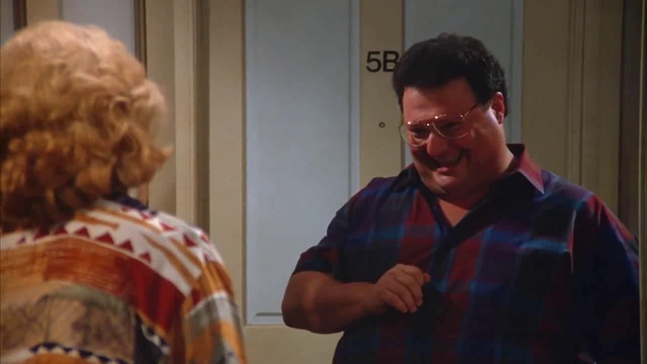 Newman smiling in front of Mrs. Seinfeld in &quot;Seinfeld&quot;