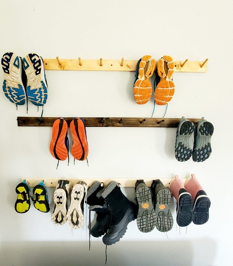Various pairs of shoes placed on rack