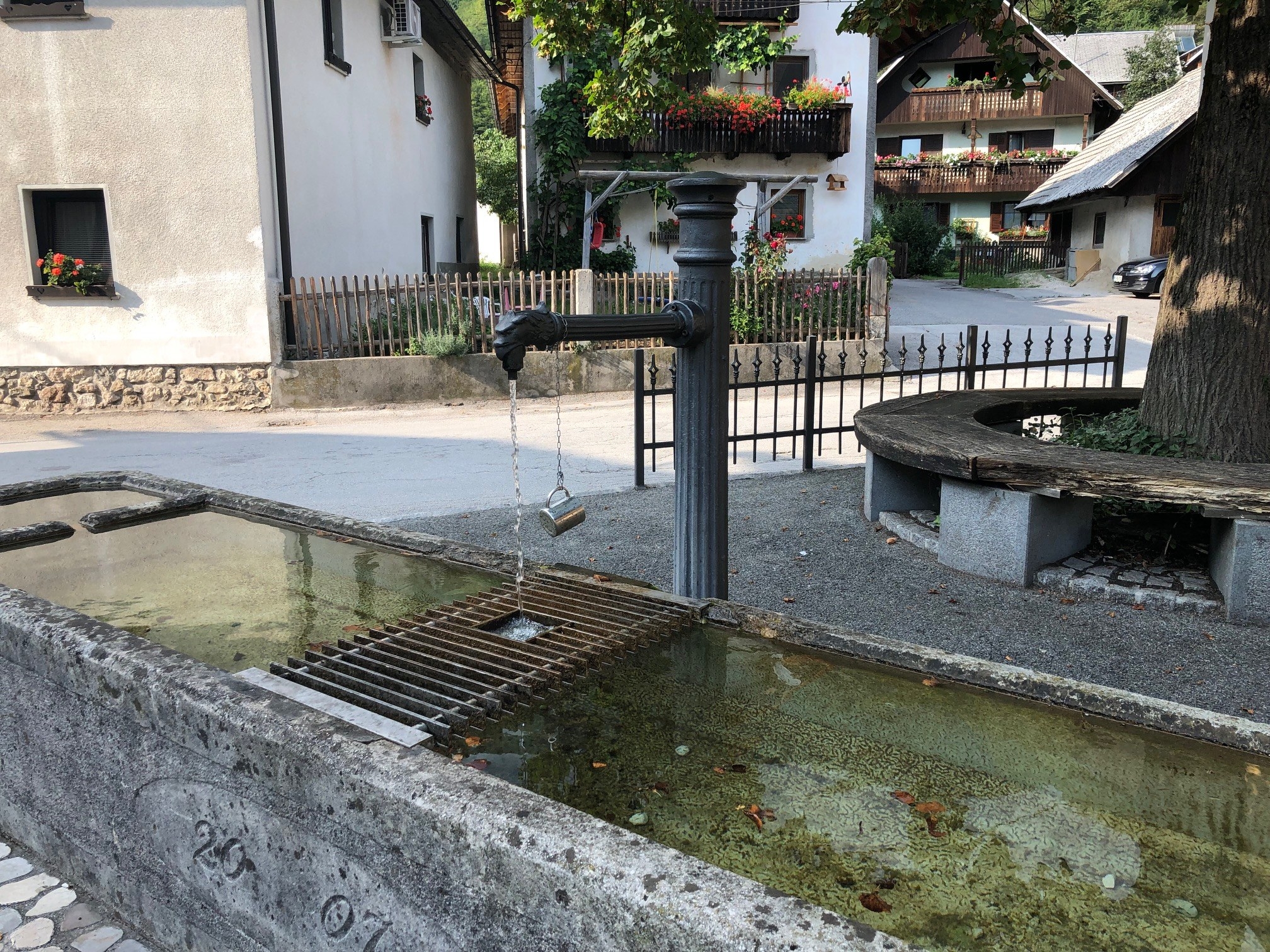 Public water fountain with cup attached