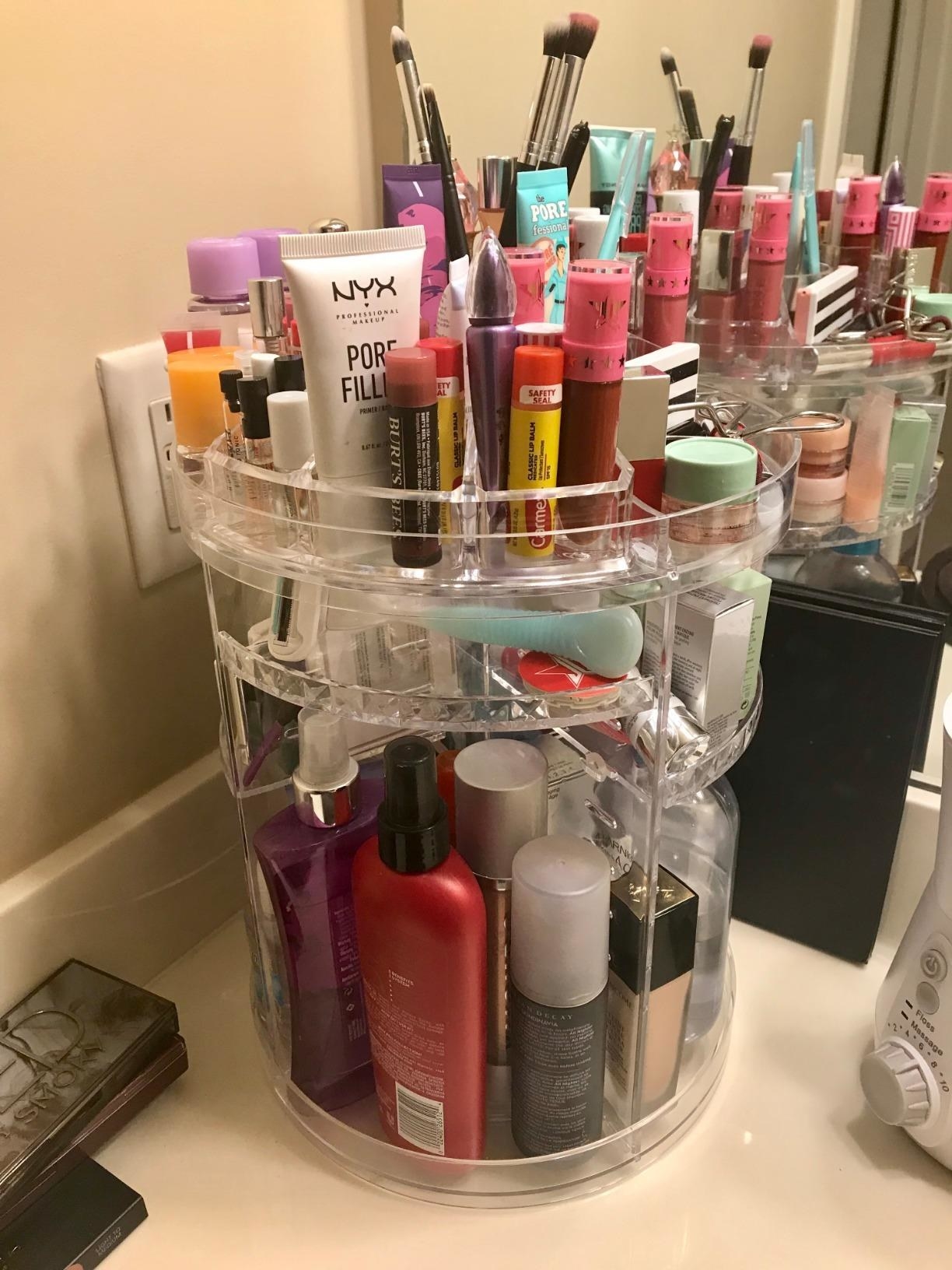 a reviewer&#x27;s organizer in the corner of their counter full of personal care items