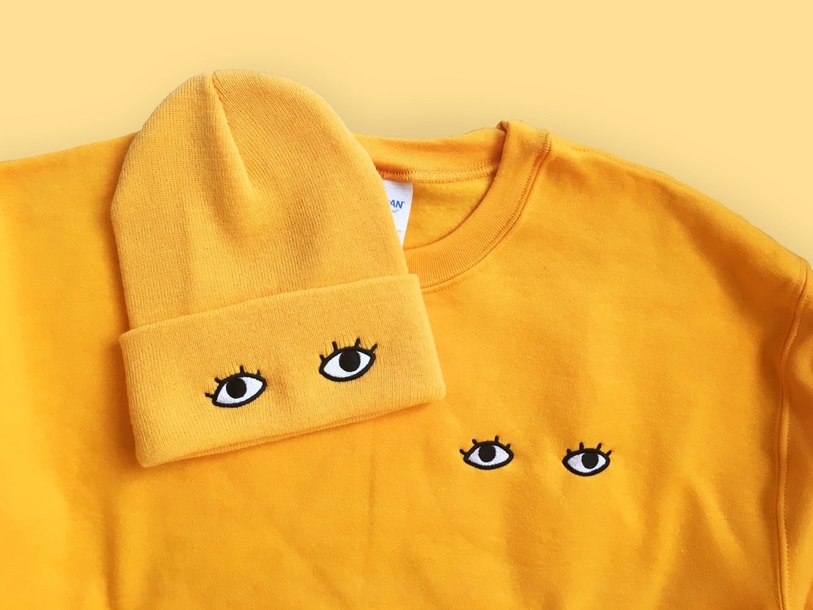 beanie and sweatshirt with matching eye designs embroidered