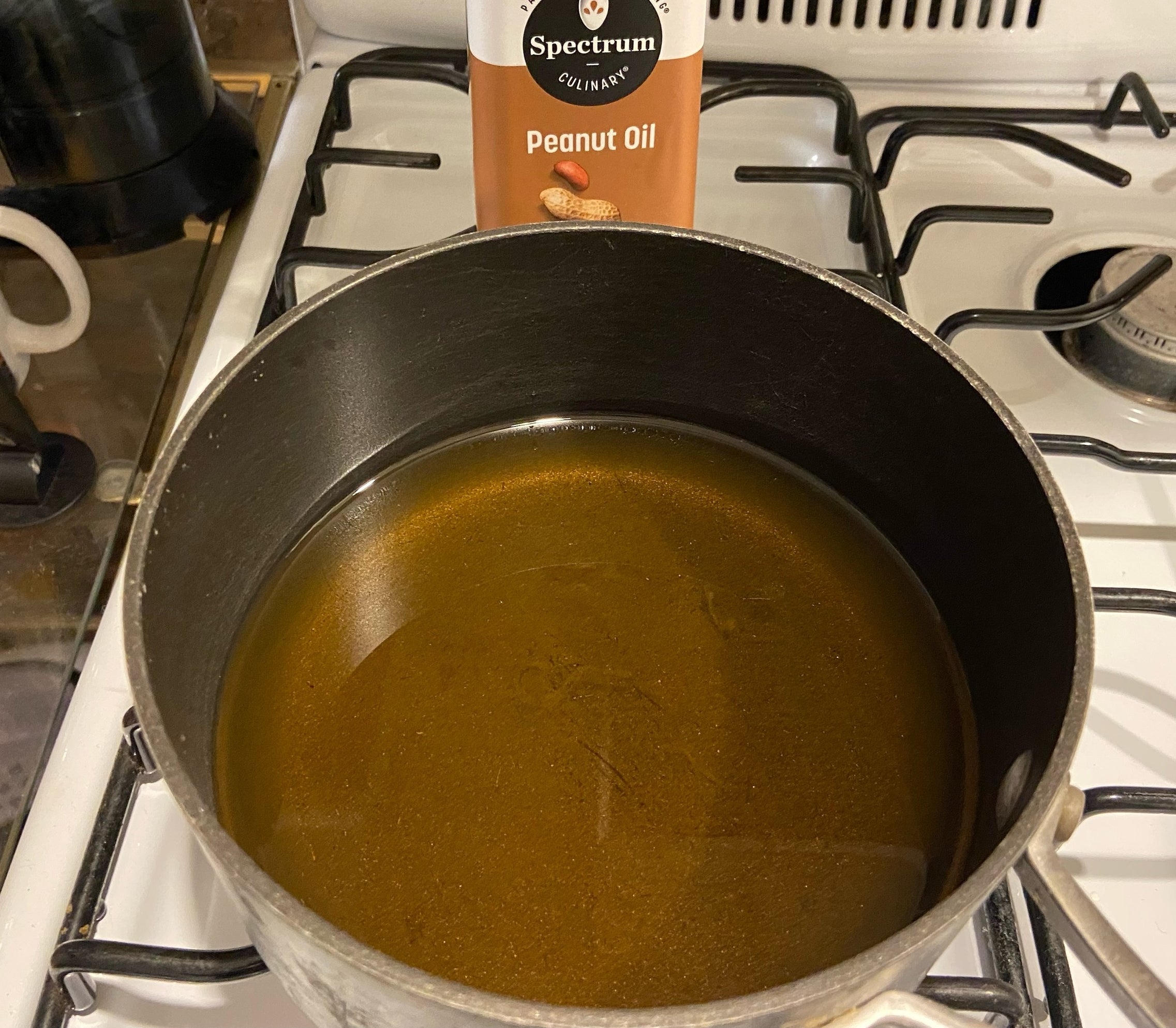 The oil in the a frying pan.