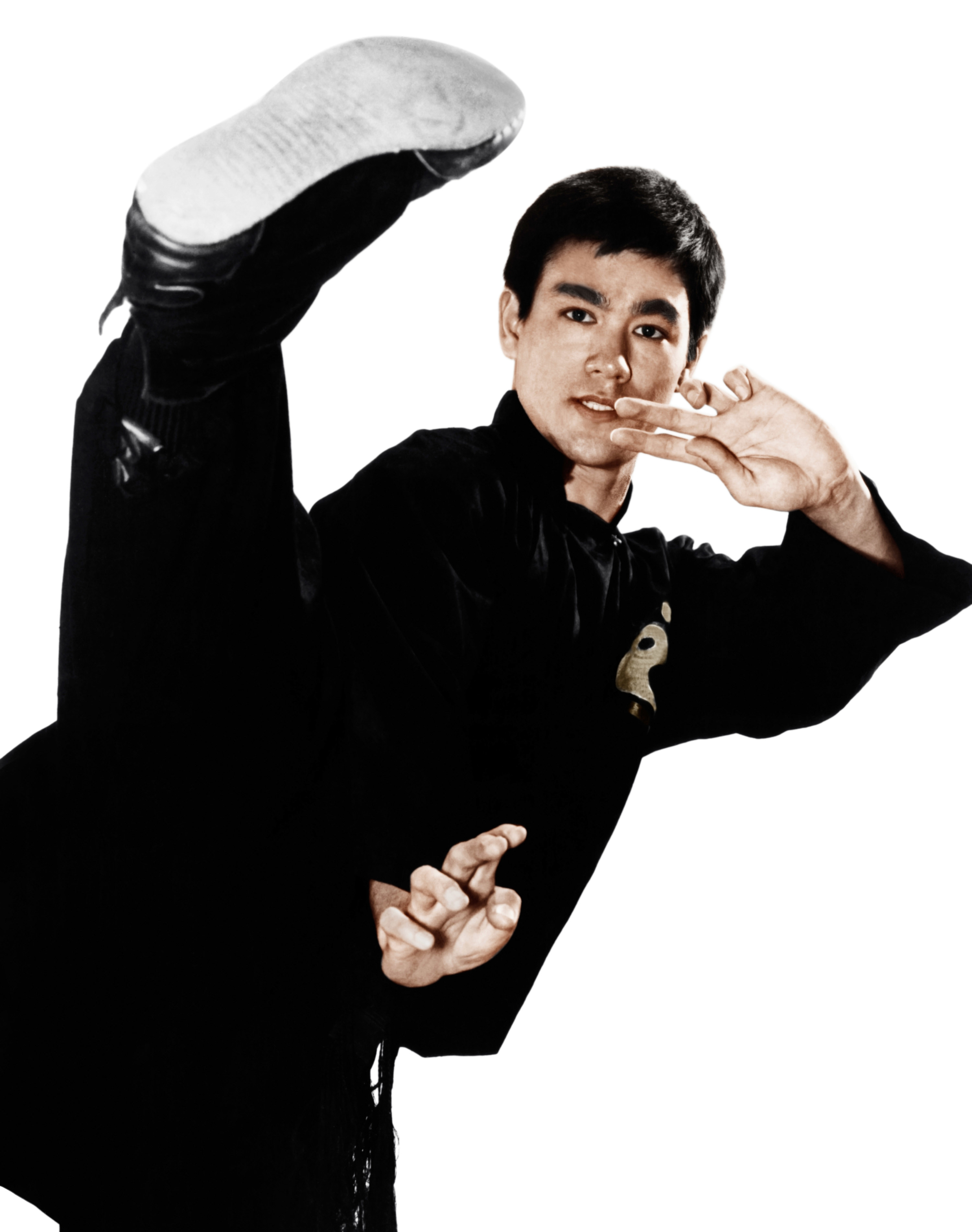 Bruce Lee in costume doing a karate kick