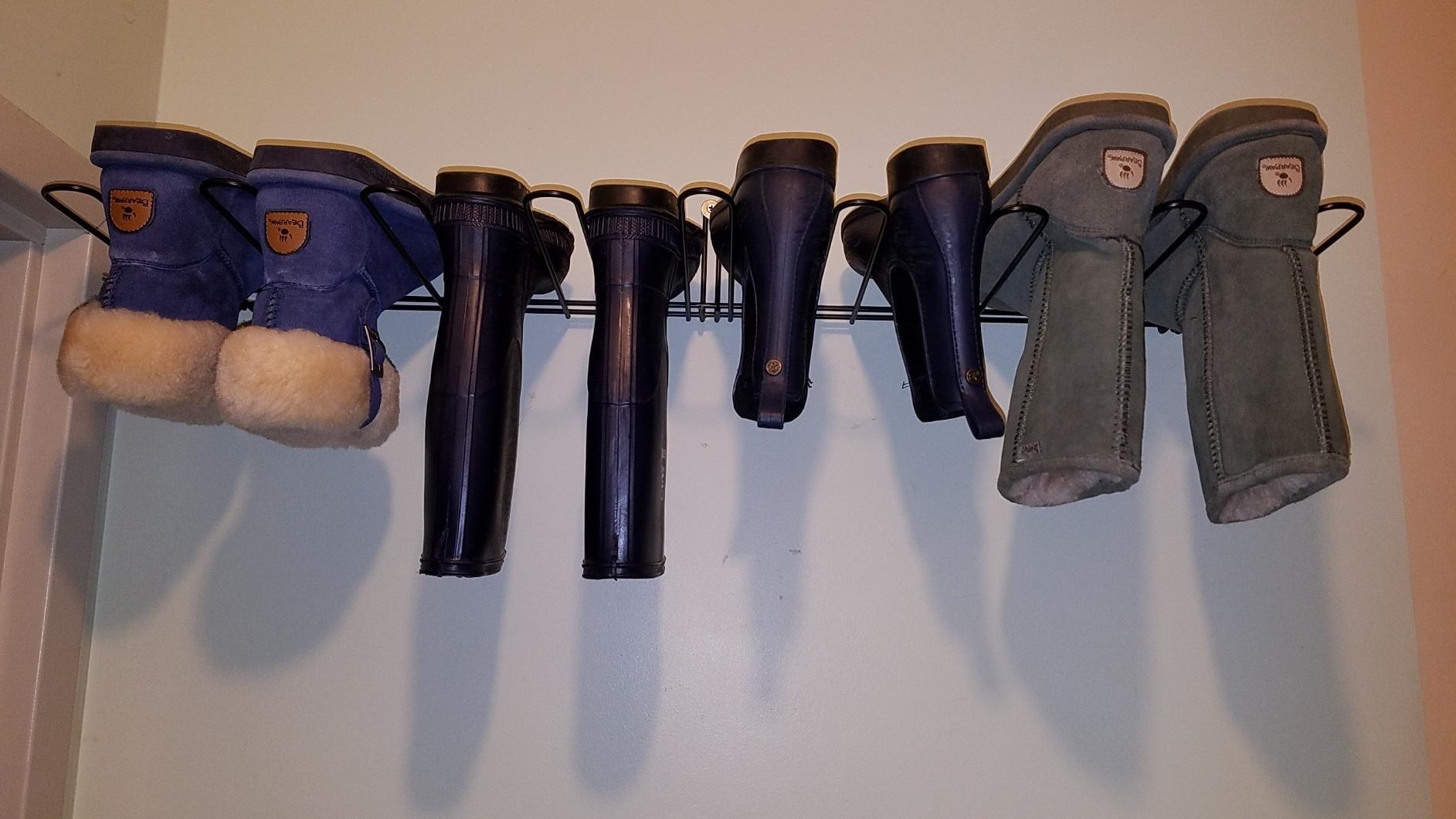 Reviewer&#x27;s boots on hanging rack