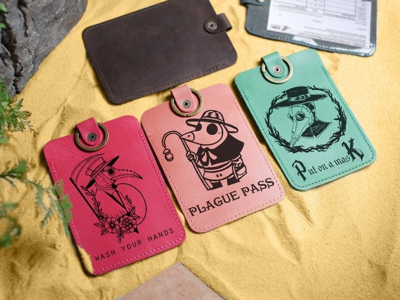three plague-themed cardholders lined up