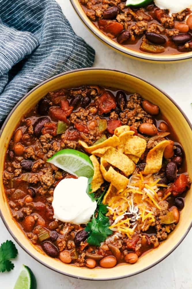 Beef and bean chili with cheese, sour cream, and tortilla chips.