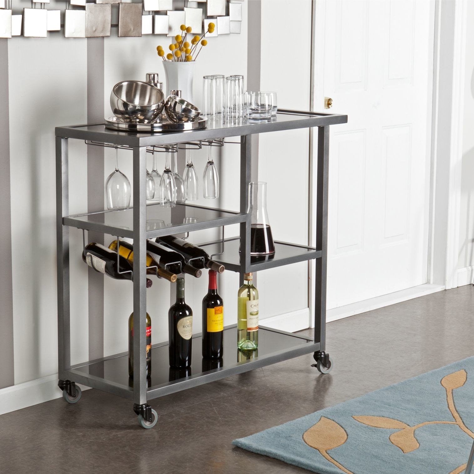 A charcoal metal bar cart with four shelves, 4 wine bottle rack, and 8 wine glasses rack on wheels