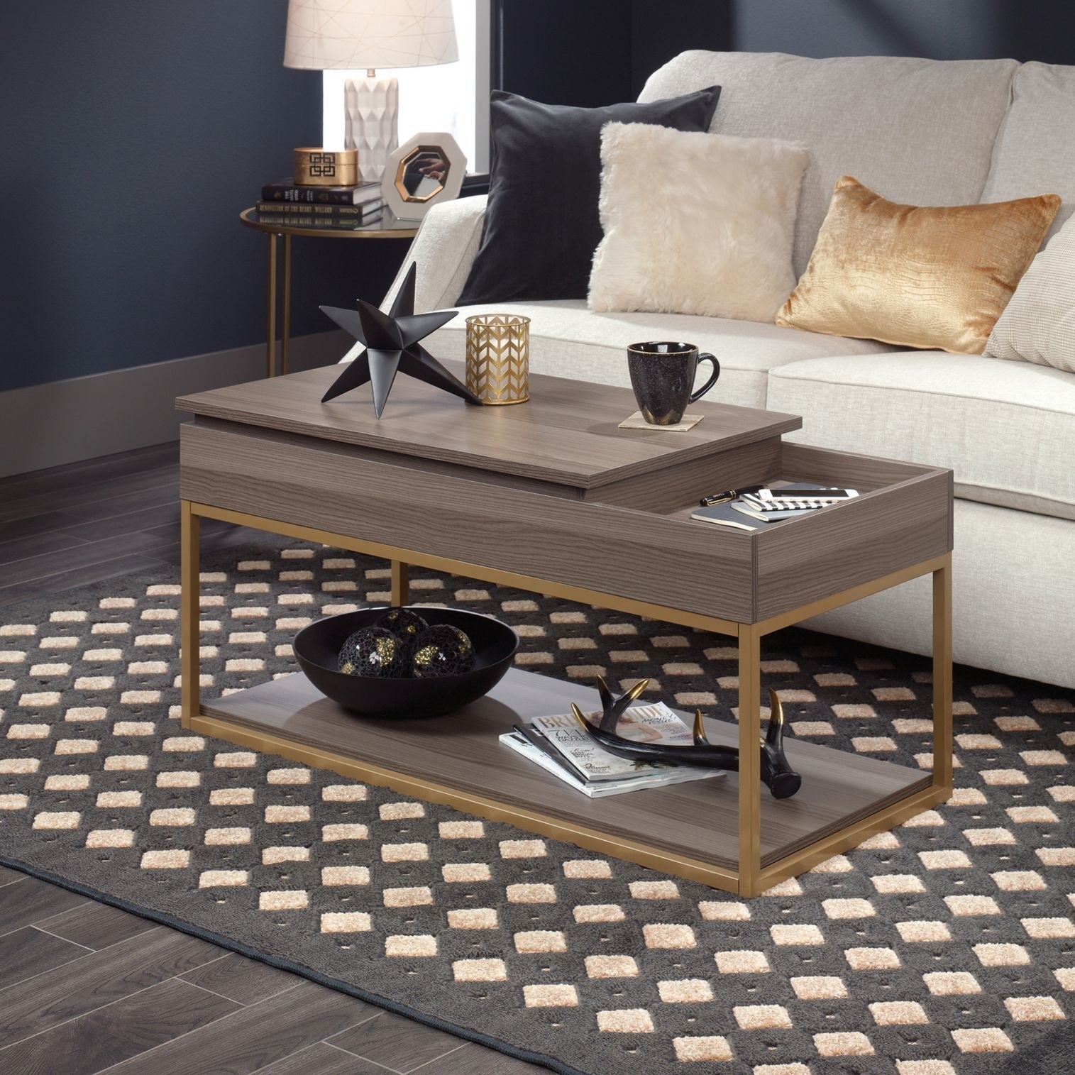A brown lift top coffee table with a gold metal frame