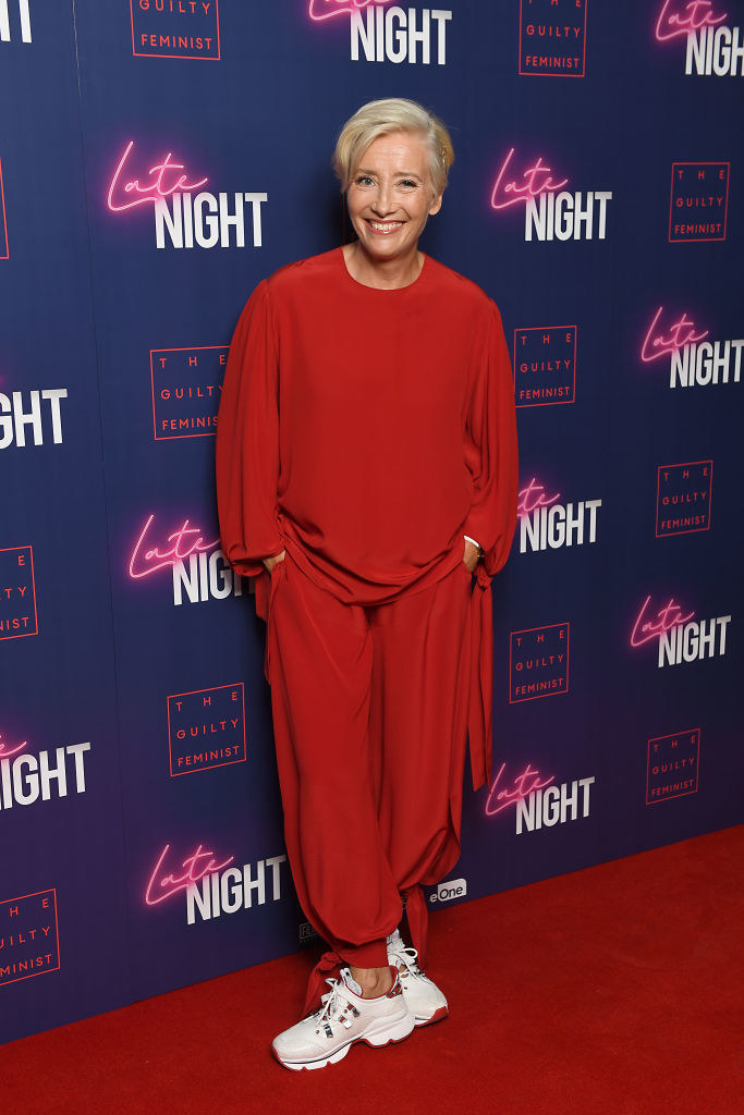 Emma at a red carpet event wearing a flow-y top with matching pants and sneakers