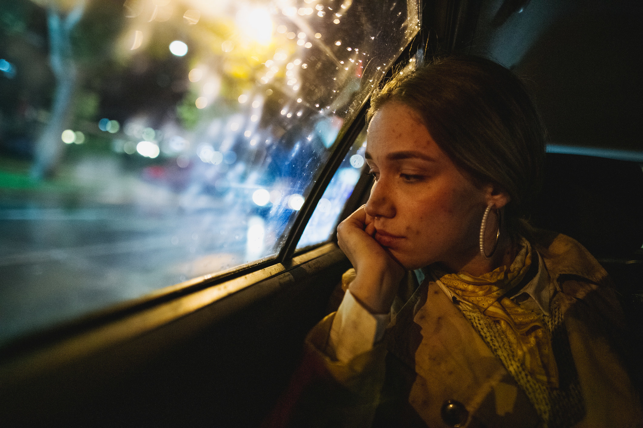 Sad woman lost in thought in back of cab