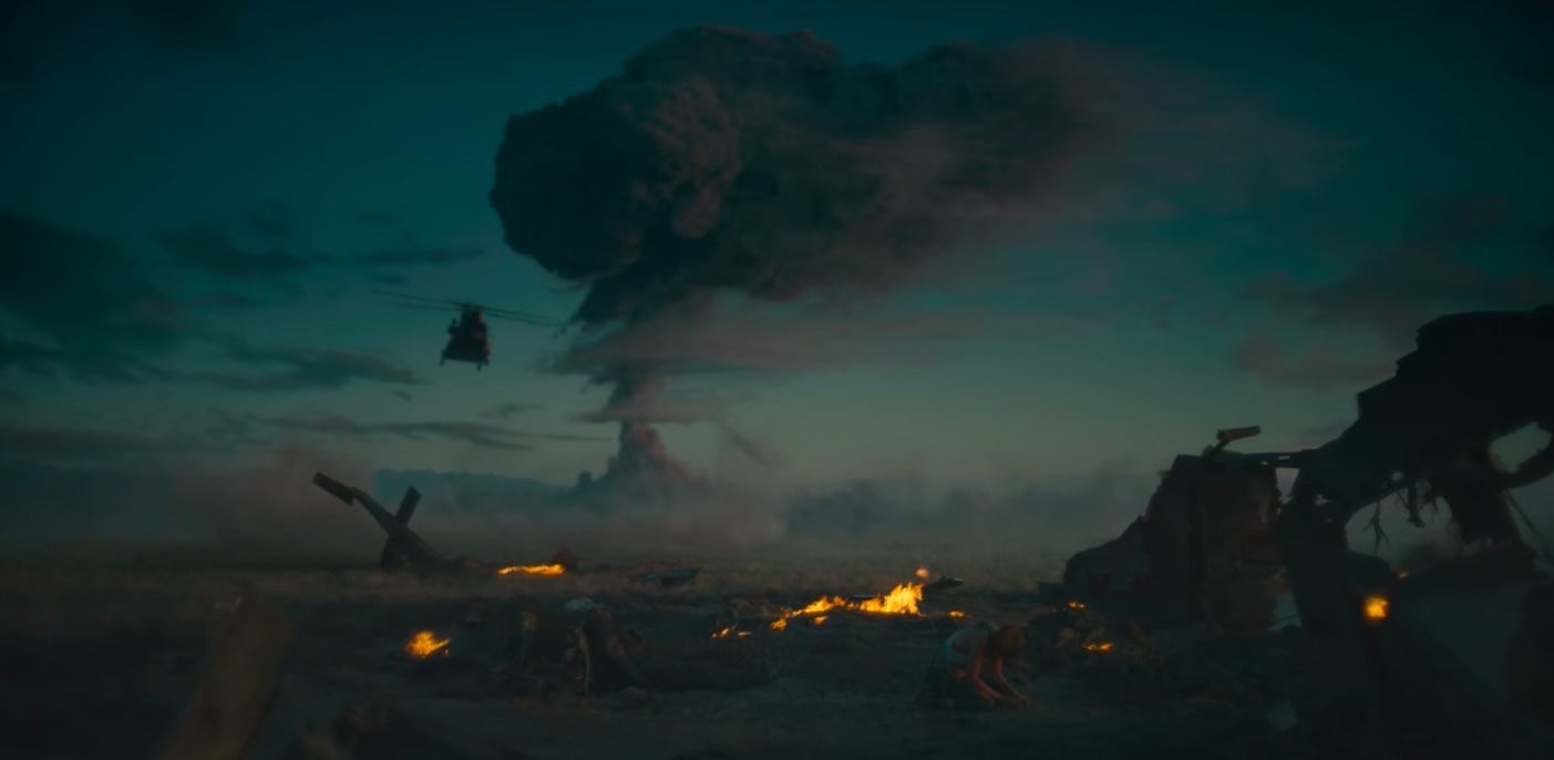 Kate sitting on the ground crying with a mushroom cloud in the background in &quot;Army of the Dead&quot;