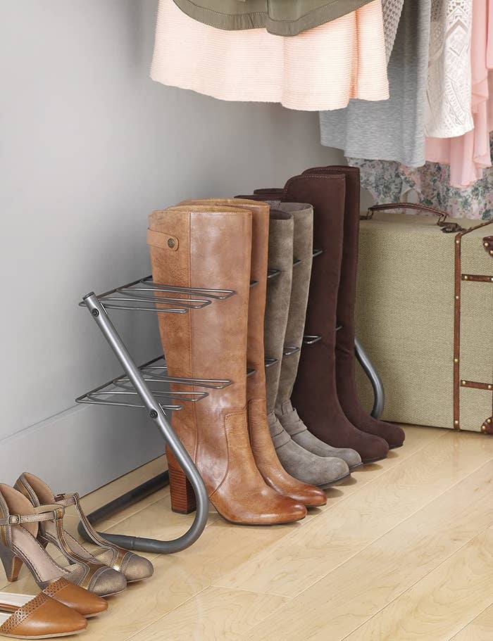 Set of three boots placed in rack