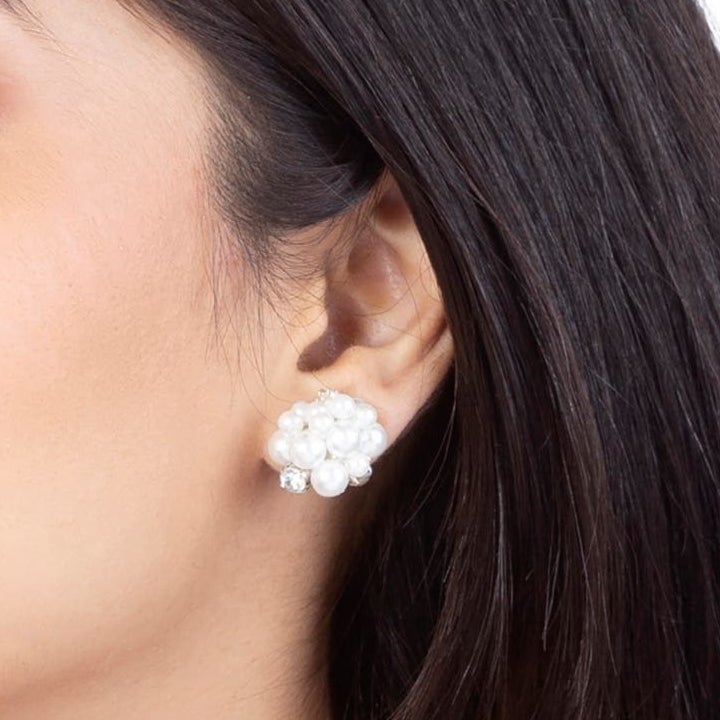 Model wearing the white pearl cluster earrings