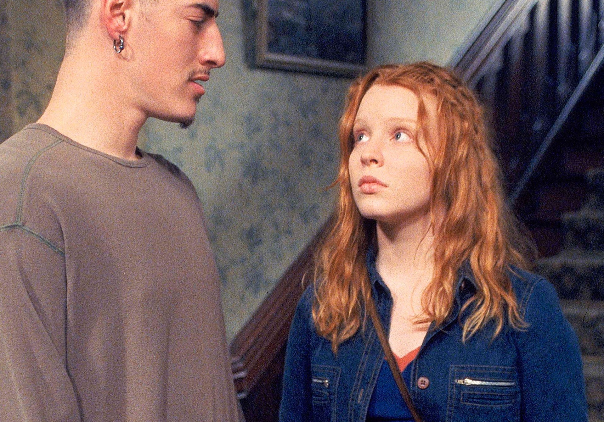 Red-headed teen girl looking at boyfriend