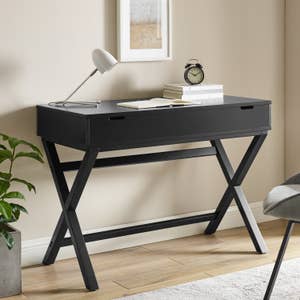 black desk with two drawers underneath it