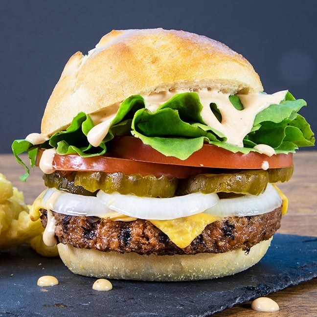 a burger with the plant-based patty topped with classic burger toppings