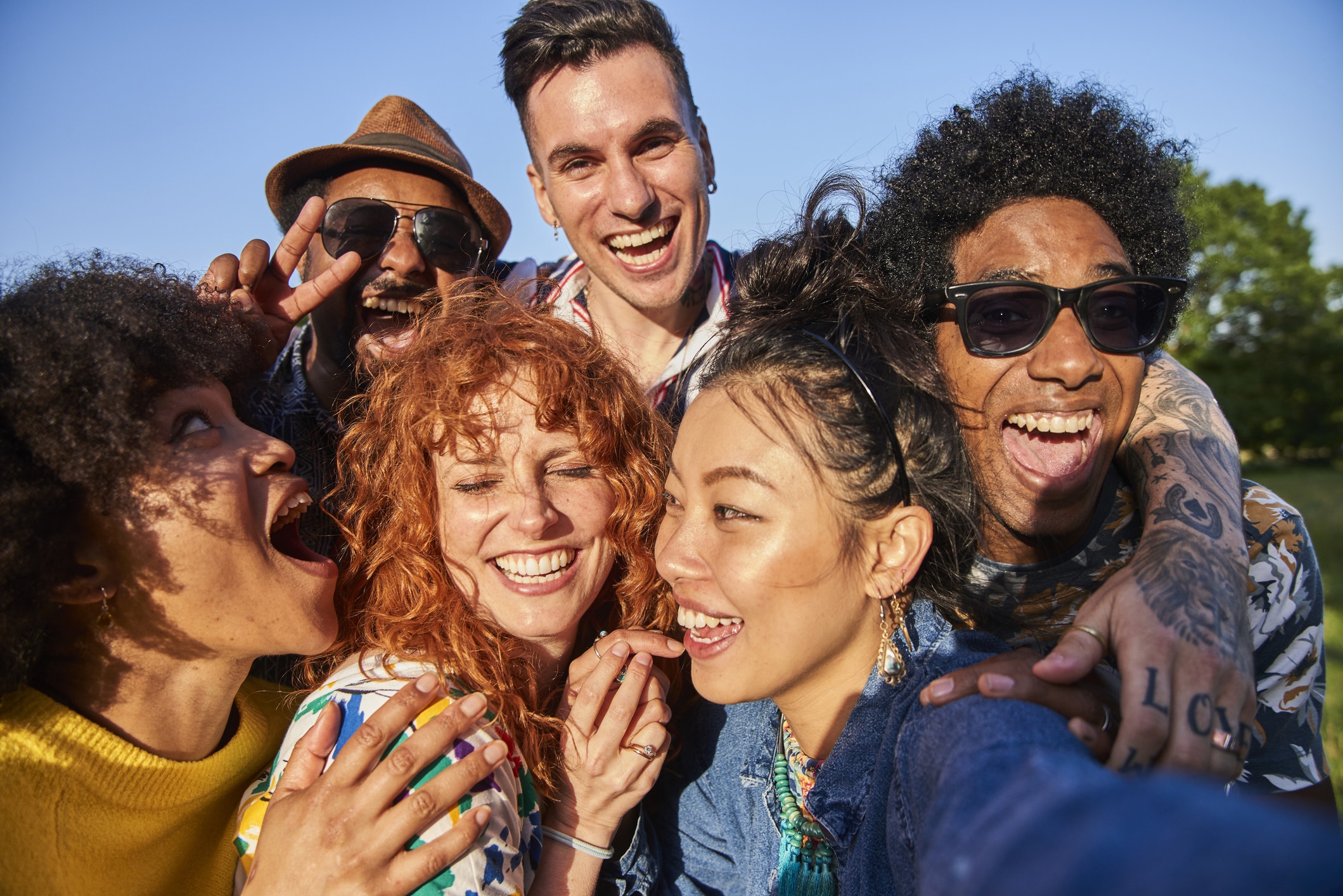 A group of adult friends pose for a selfie