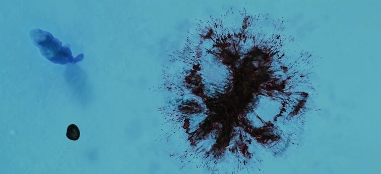 Overhead shot of Dr. Manhattan looking at Rorschach&#x27;s blood in the snow in &quot;Watchmen&quot;