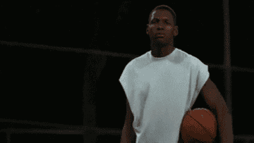 Jesus Shuttlesworth stands with a basketball