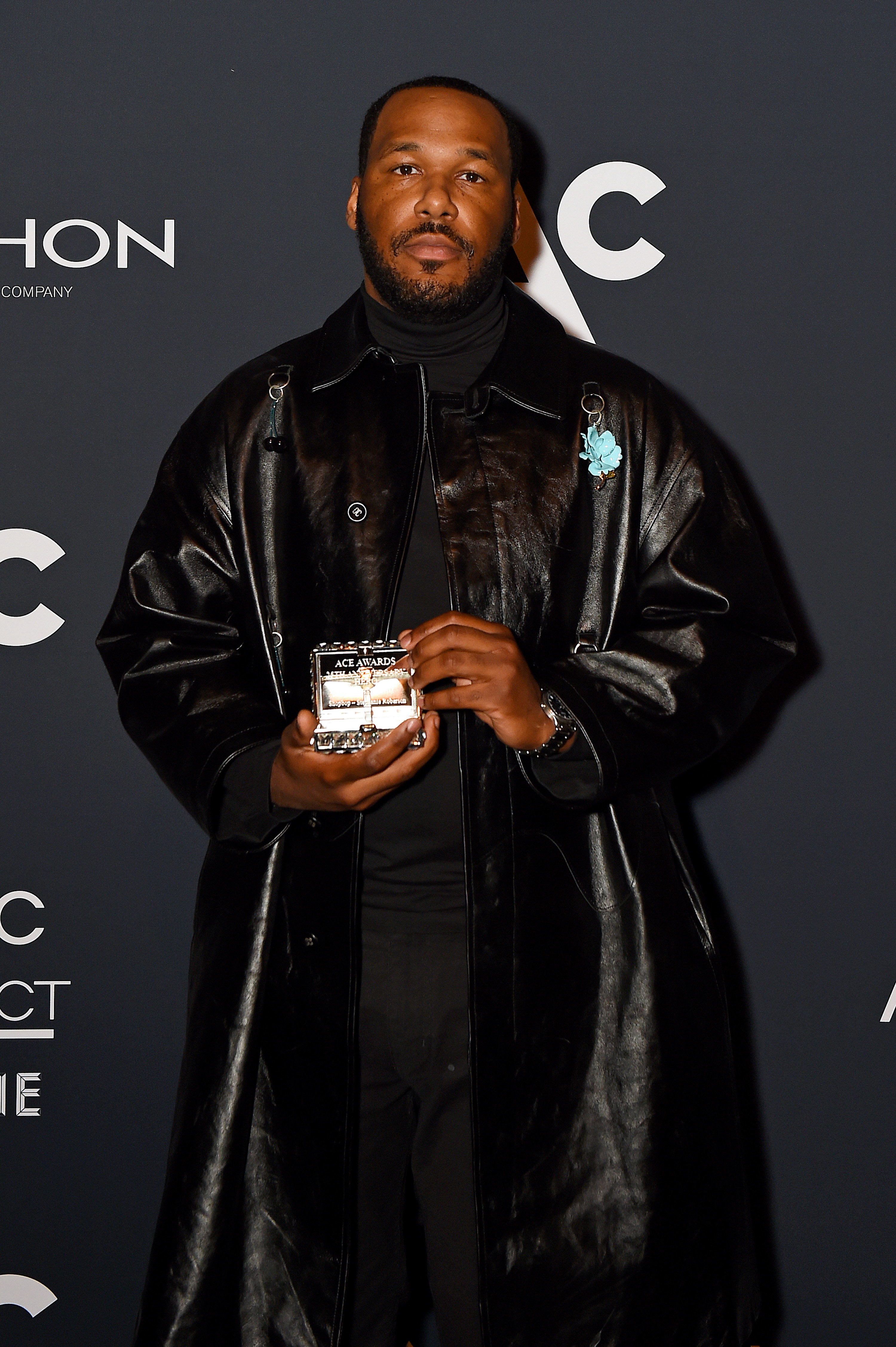 Jason Rembert poses with an award for Shopbop during the 25th Annual ACE Awards