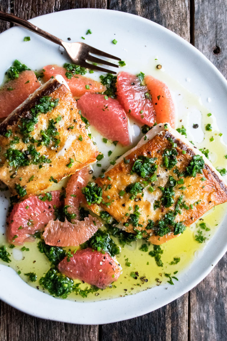 Halibut fillets with green herb sauce and grapefruit.