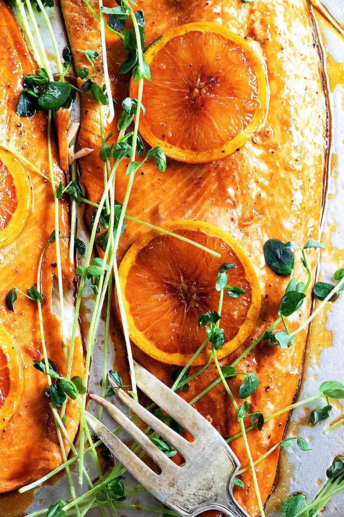 A fillet of orange salmon with herbs.